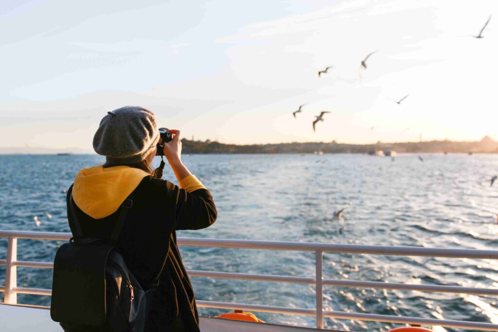 Tourist woman taking travel picture with camera of
